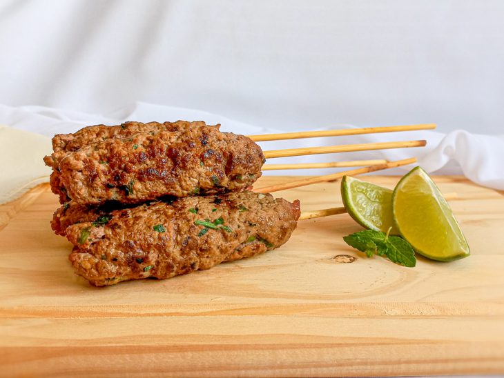 Kaftas prontas para consumo sobre uma tábu, acompanhadas por limão.