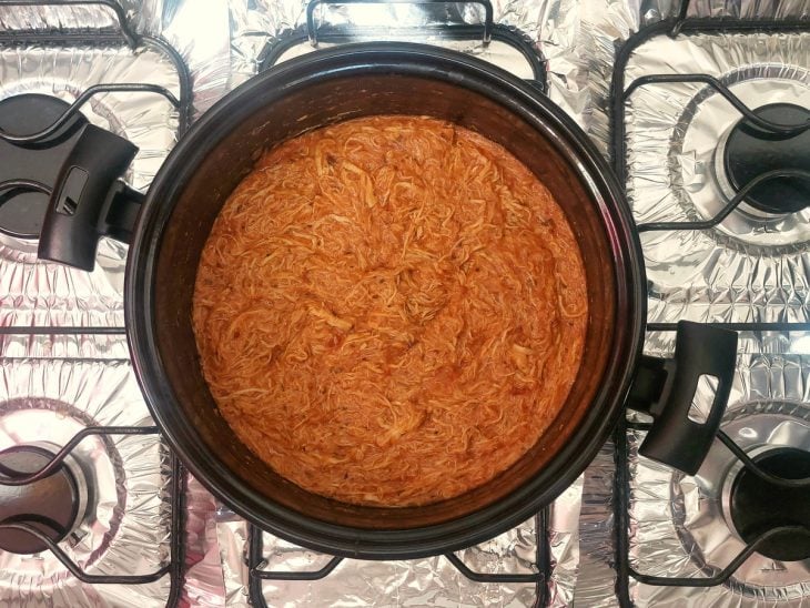 Uma panela com molho para lasanha ao fogo.