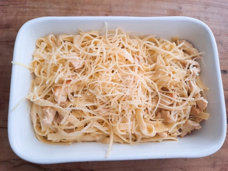 Um refratário com o macarrão e parmesão ralado.