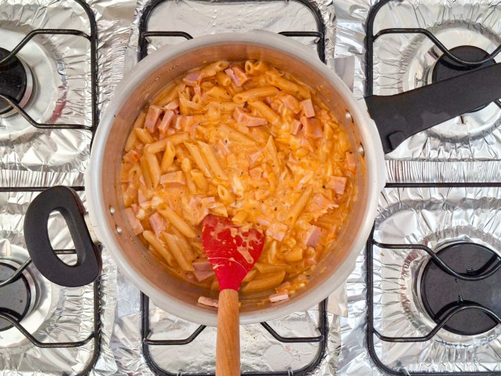 Queijo e presunto adicionados na panela de pressão.