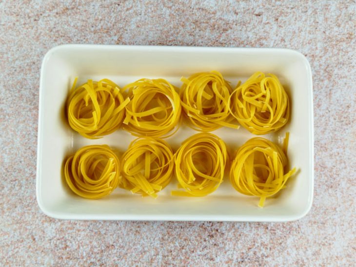 Ninhos de macarrão acomodados em um recipiente.