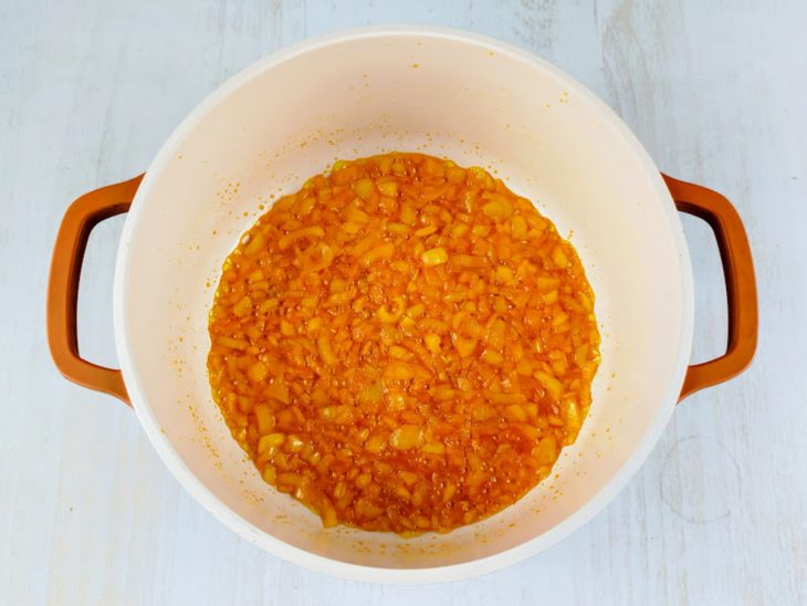 Cebola refogada em uma panela com azeite.