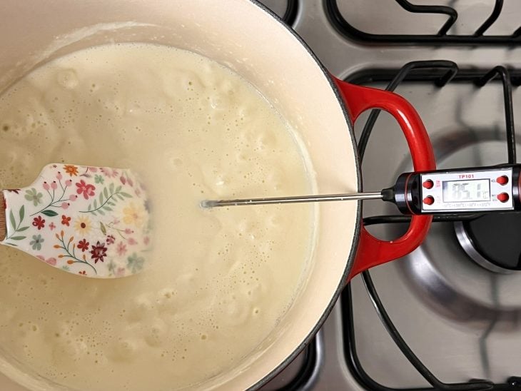 Uma panela contendo creme de leite quente com suco de limão.