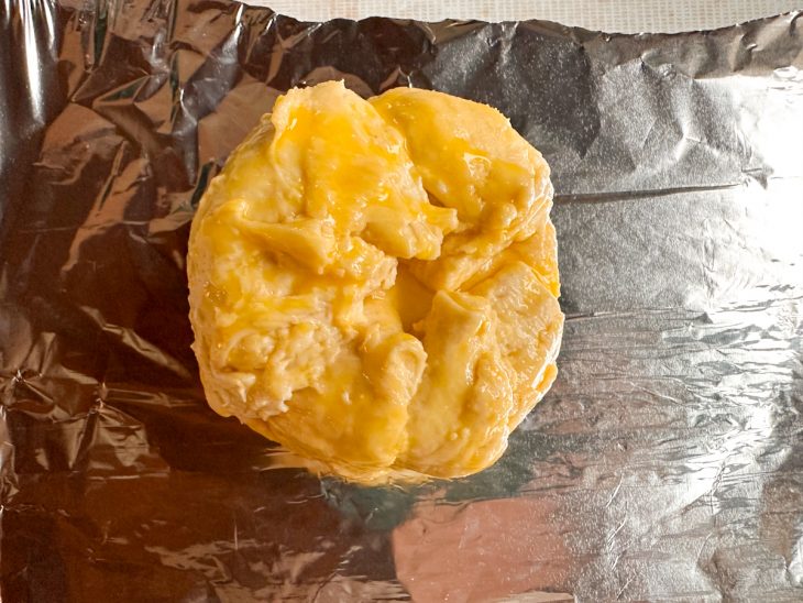 Pedaços da massa dobrada sobre o queijo.