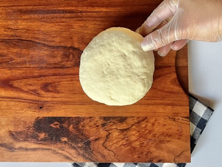 Uma tábua com a massa para ser sovada.