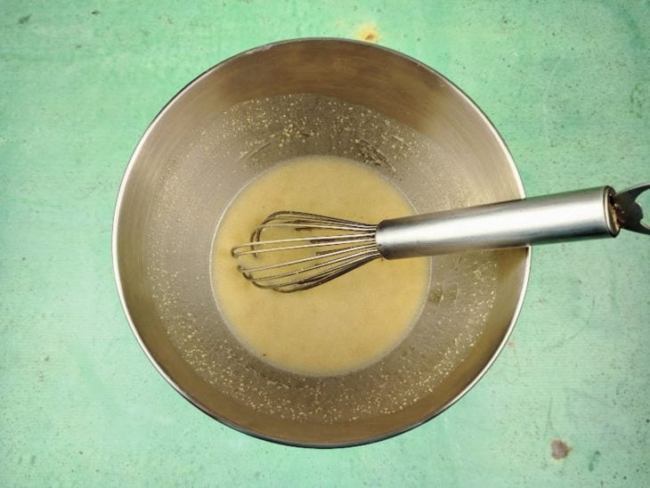 Uma tigela com leite, ovo, creme de cebola, óleo, açúcar, sal e fermento.