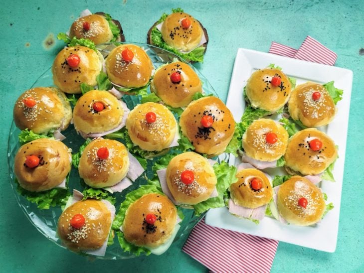 Pratos contendo minissanduíche para festa.