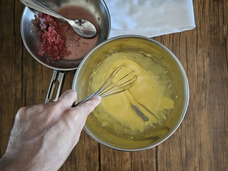 Tigela com o molho e a panela ao lado com cebola roxa.