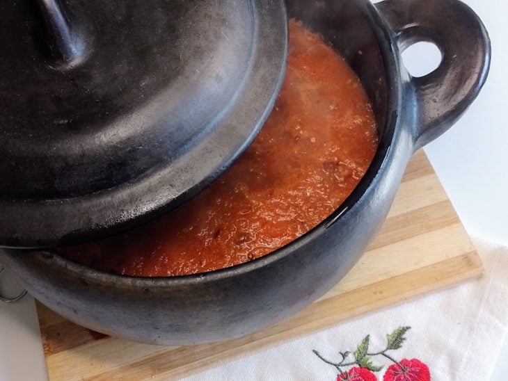 Uma panela cozinhando molho de tomate.