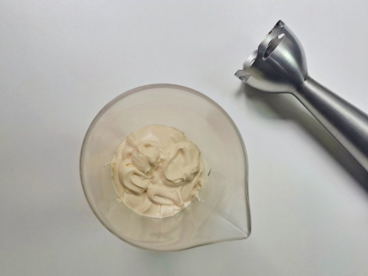 Maionese caseira preparada em um recipiente com auxílio de um mixer.