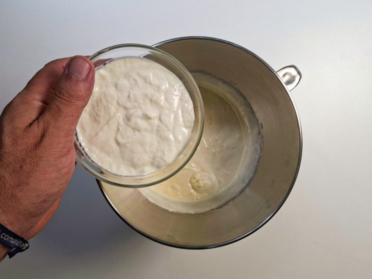 Creme de leite sendo adicionado à mistura ainda na batedeira.
