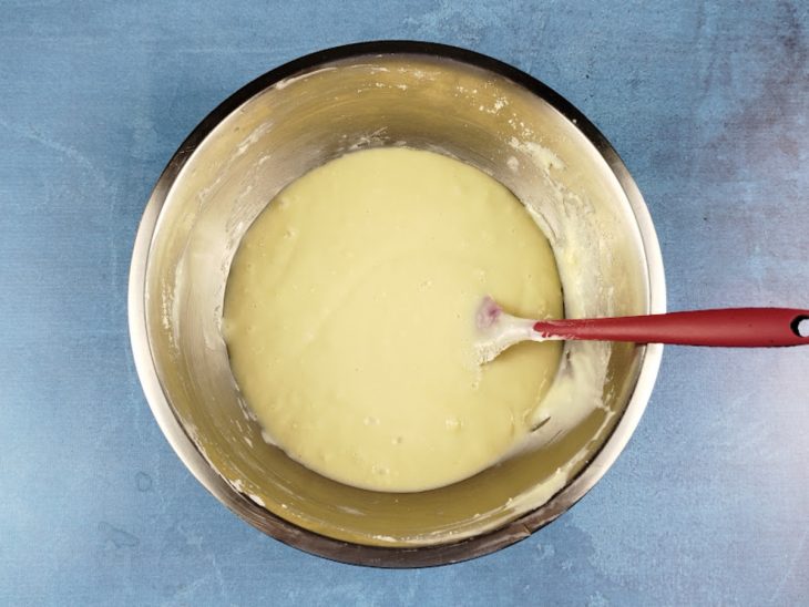 Numa tigela, o leite em pó, o creme de leite, e o leite condensado misturados.