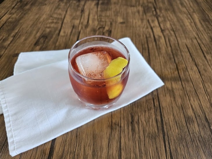 Casca adicionada dentro do copo com negroni.