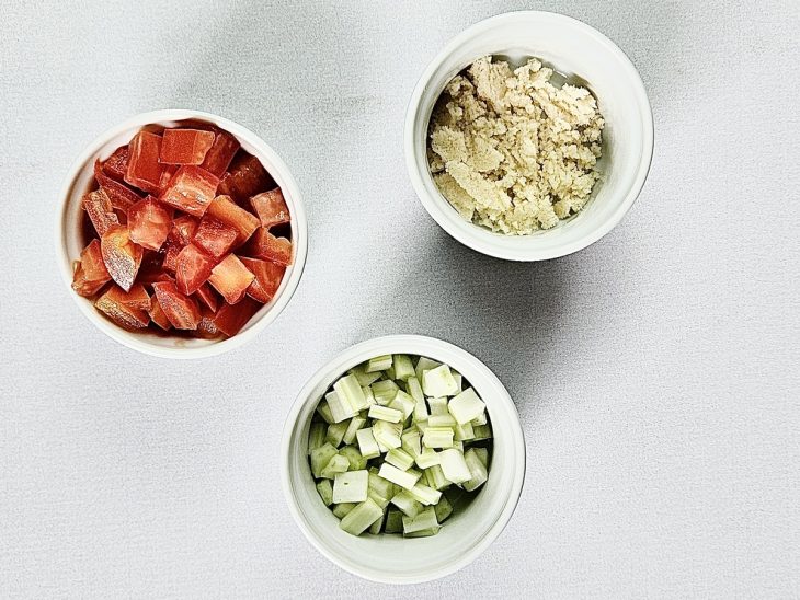 Tomate, alho e cebola picados em potinhos.
