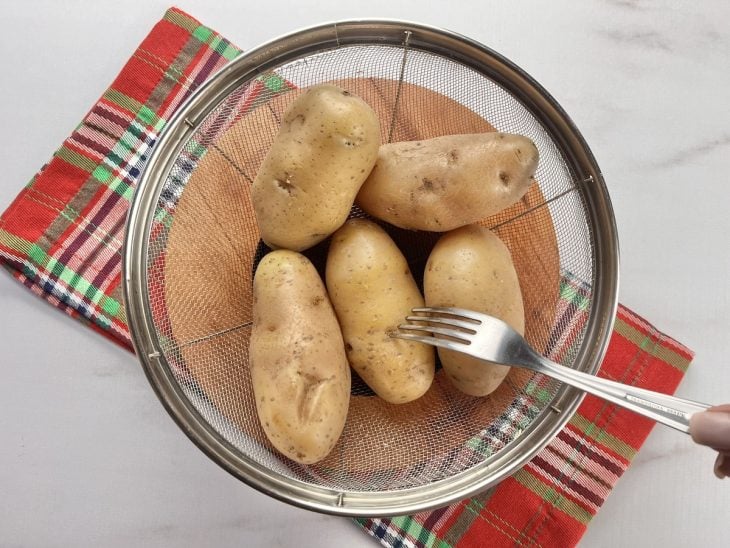 Um recipiente com batatas após cozimento.