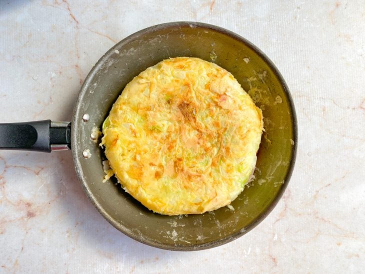 Frigideira com o okonomiyaki virado.