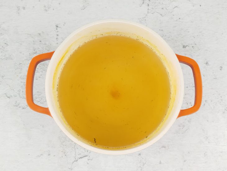 Caldo coado e reservado.