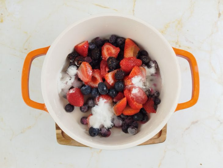Frutas vermelhas com açúcar na panela.