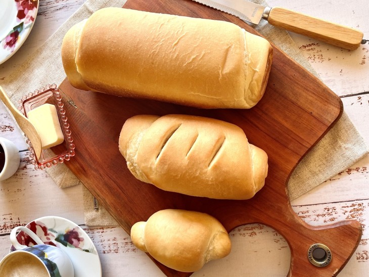 Pães assados prontos para servir em cima de uma tábua.