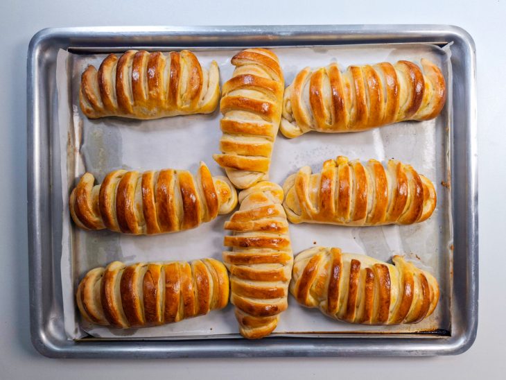 Pães transferidos para uma forma, pincelados com a gema.
