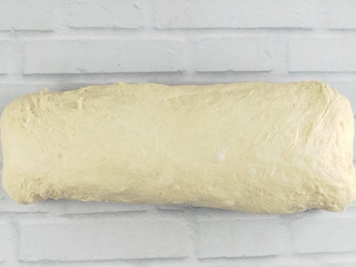 Na bancada, a massa dobrada e fechada.