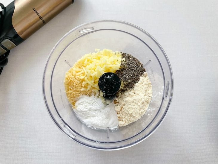 Ingredientes sendo batidos no processador até formar massa pegajosa.