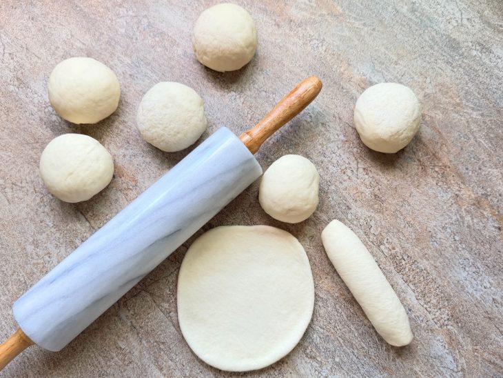 Pedaços da massa abertos e enrolados.