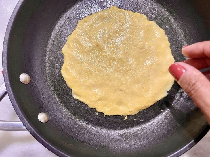 Porção da massa aberta na frigideira.