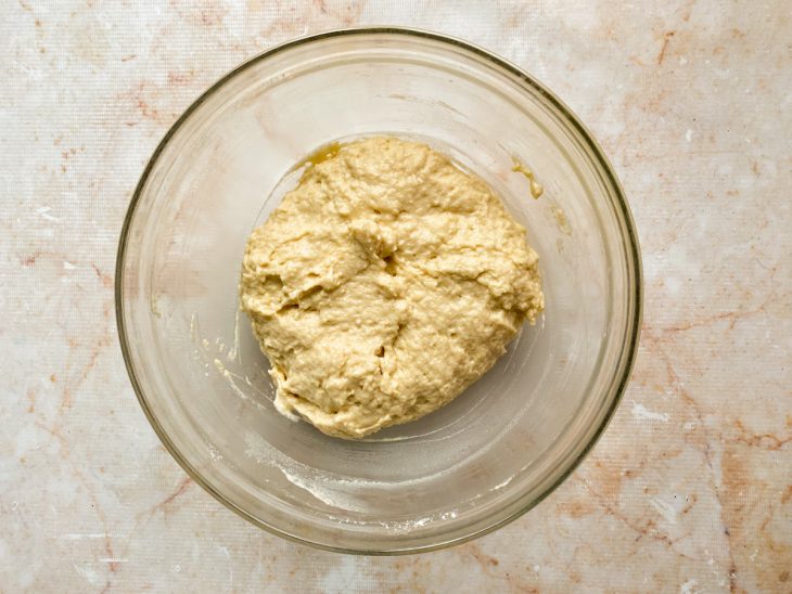 Mistura do liquidificador e farinha misturados em uma tigela de vidro.