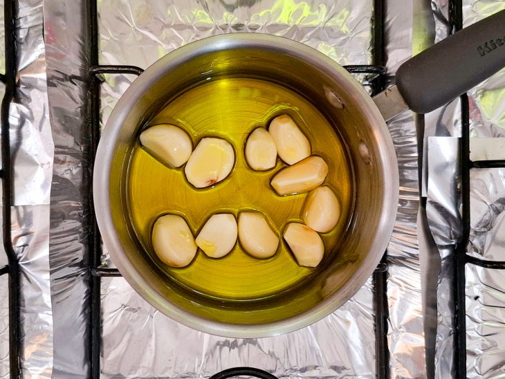 Numa panela, o azeite, o sal e o alho estão adicionados.