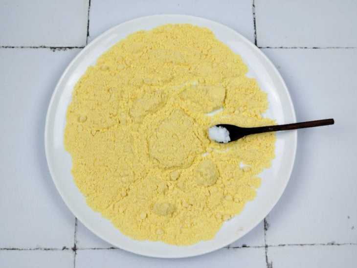 Um prato contendo a mistura de fubá e sal.