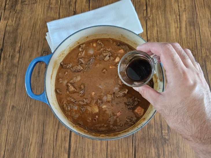 Líquidos adicionados à panela com carne e outros ingredientes.