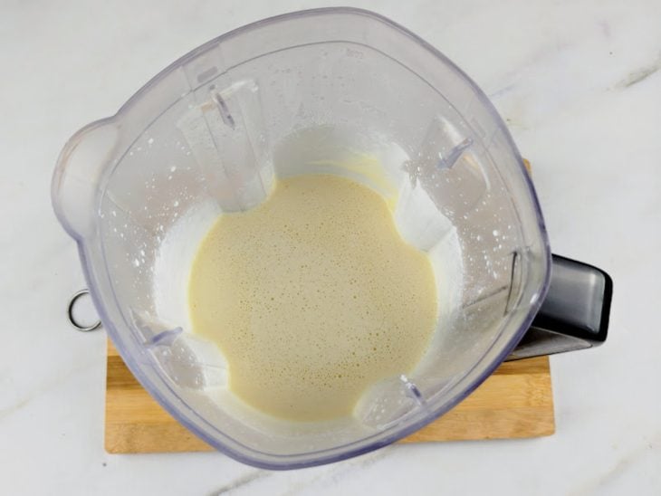 Leite, açúcar, ovos e leite em pó batidos em um liquidificador.