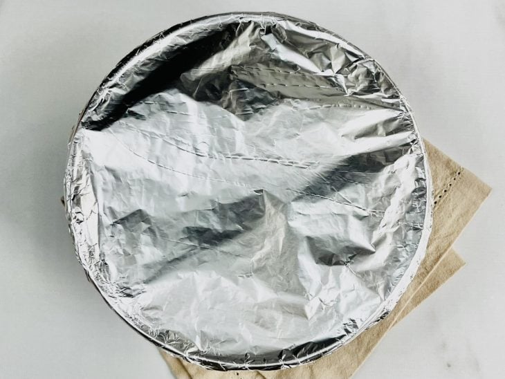 Forma com pudim coberta com papel-alumínio.