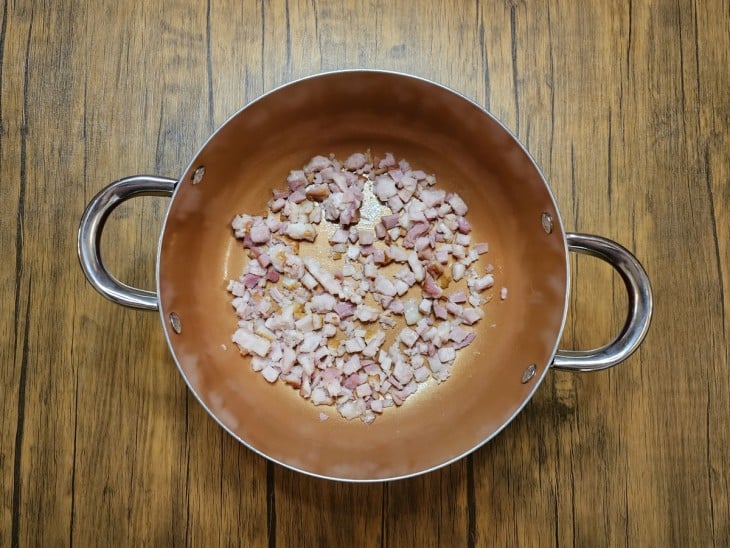 Panela com bacon em pequenos cubos.