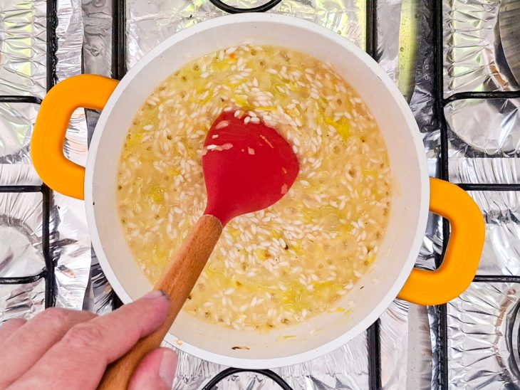 Arroz cozinhando com o caldo de legumes na panela.