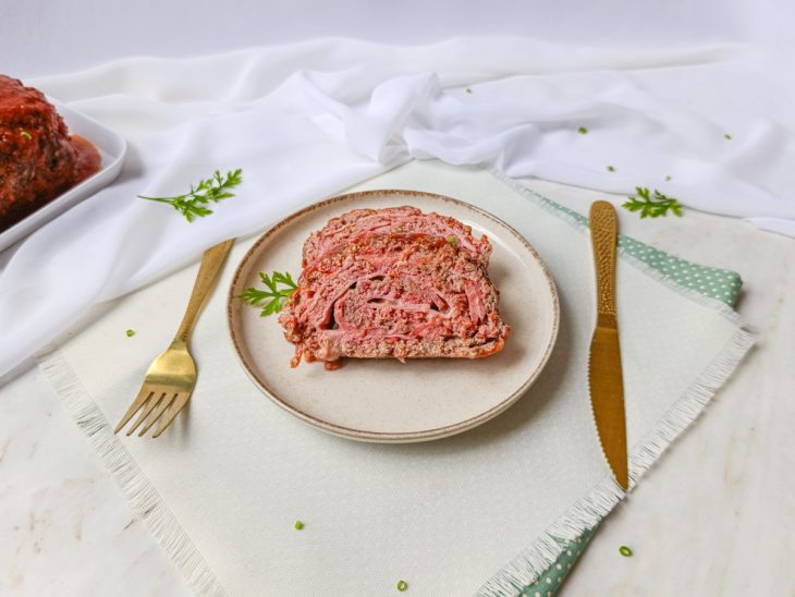 Rocambole em fatias servido num prato individual.