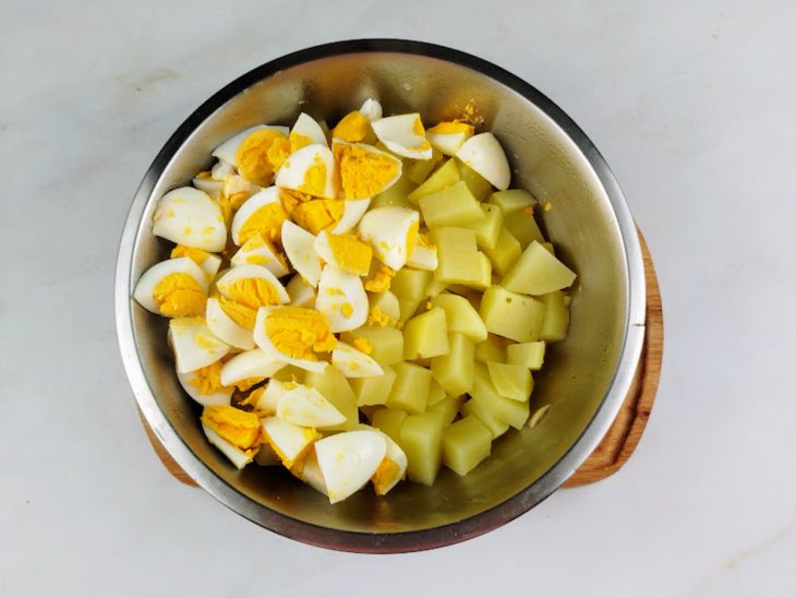 Ovos e batatas picados em uma tigela.