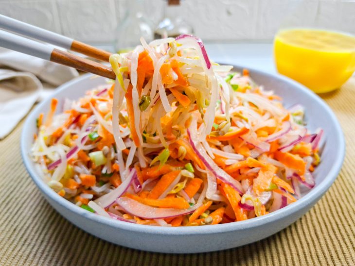 Salada de broto de feijão pronta para consumo com porção em destaque.