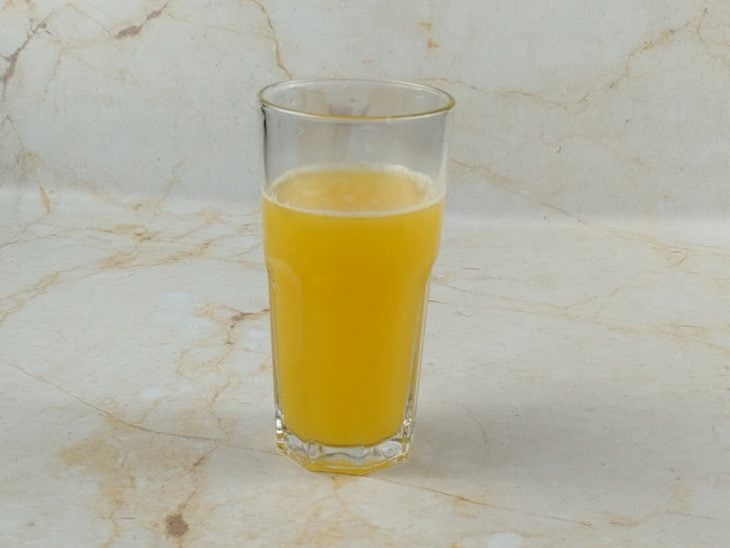 Suco das laranjas espremidas, em um copo.