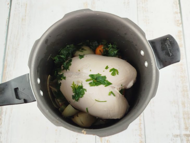 Peito de frango e salsinha sendo incorporados ao refogado.