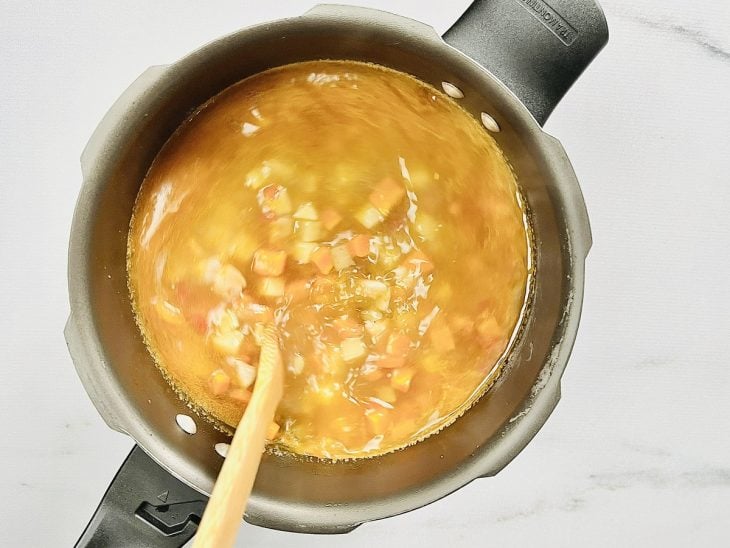 sopa de legumes com frango cozinhando na panela