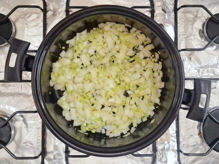 Cebola e alho-poró em uma panela com azeite.