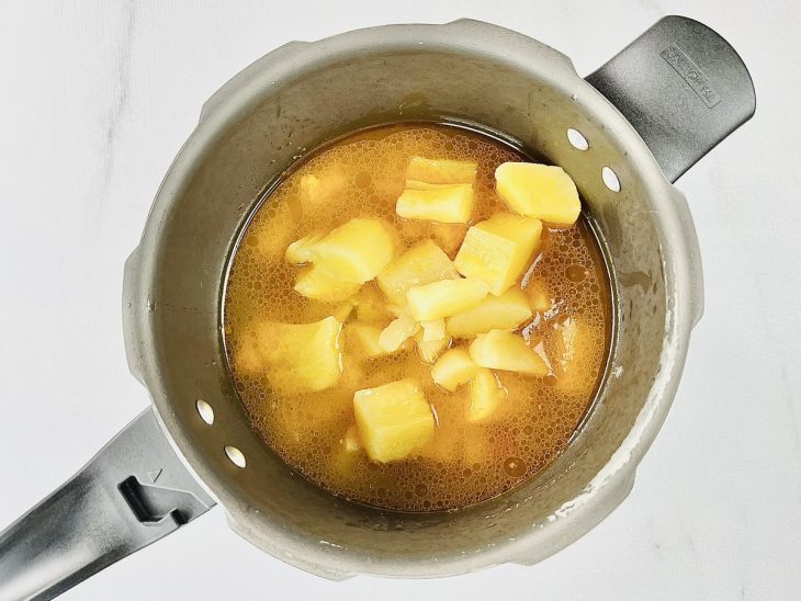 adição da mandioca e água para cozinhar a sopa.