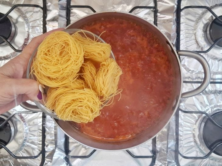 Macarrão cabelo de anjo adicionado na panela.