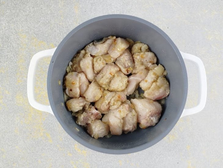 Peixe sendo adicionado à panela e dourado de ambos os lados.
