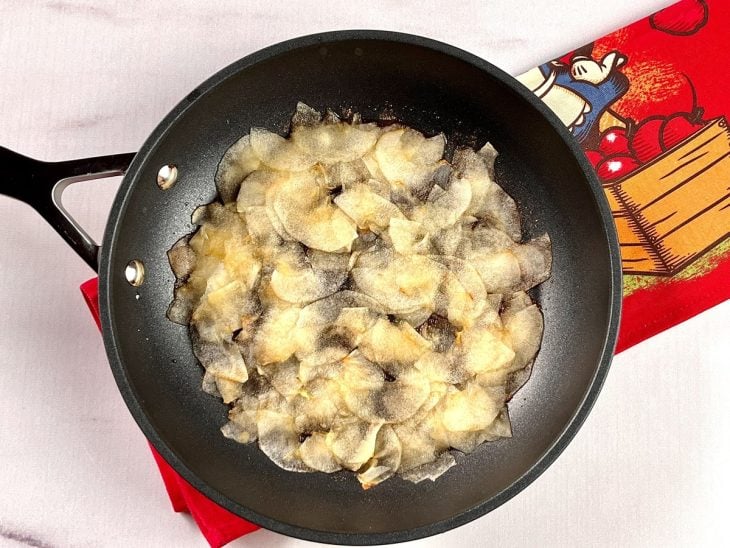 Uma frigideira forrada com as fatias de maçã.