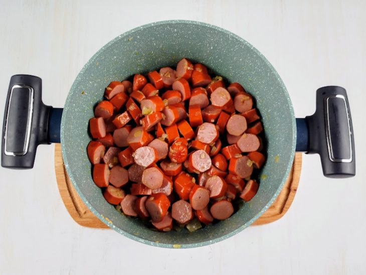 Salsichas picadas em uma panela.