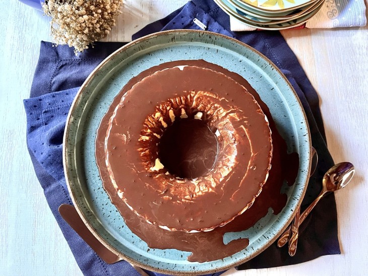 Uma recipiente contendo uma torta de sorvete com calda.