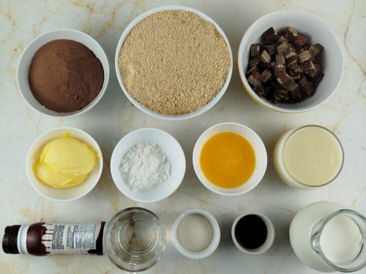 Ingredientes organizados sobre a bancada e Bis sendo picado em pedaços pequenos.